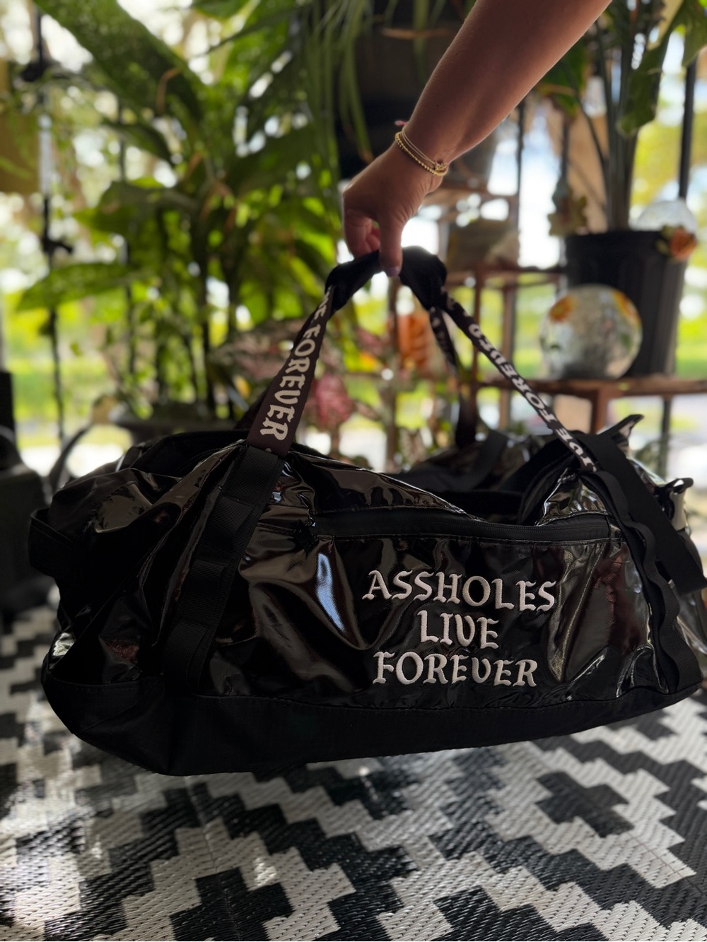 Black Glossy Duffle Bag with White Script - Assholes Live Forever